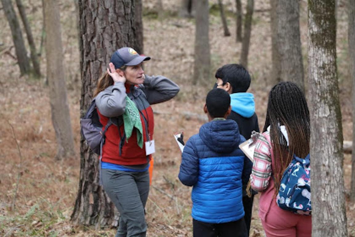 Jennifer Browndorf leads a group of young students through an outdoor lesson