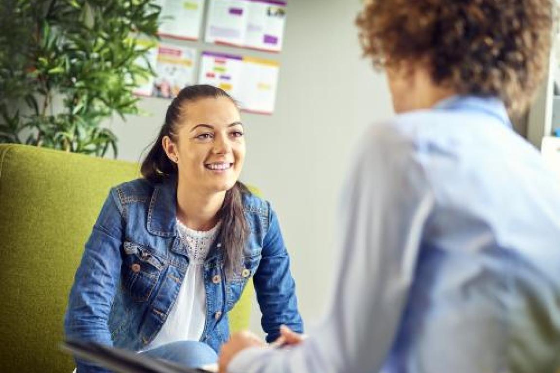 A youth employee smiles at an employer during an interview